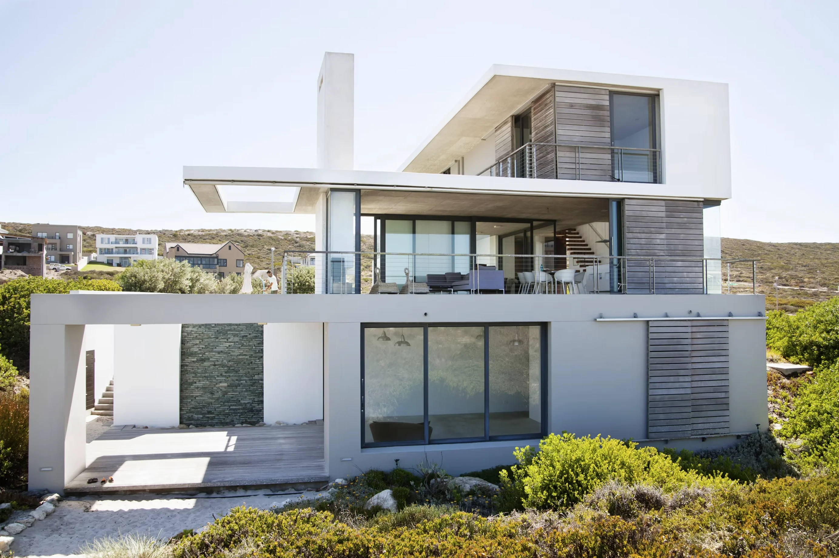 Modern two-story house with large windows and a terrace